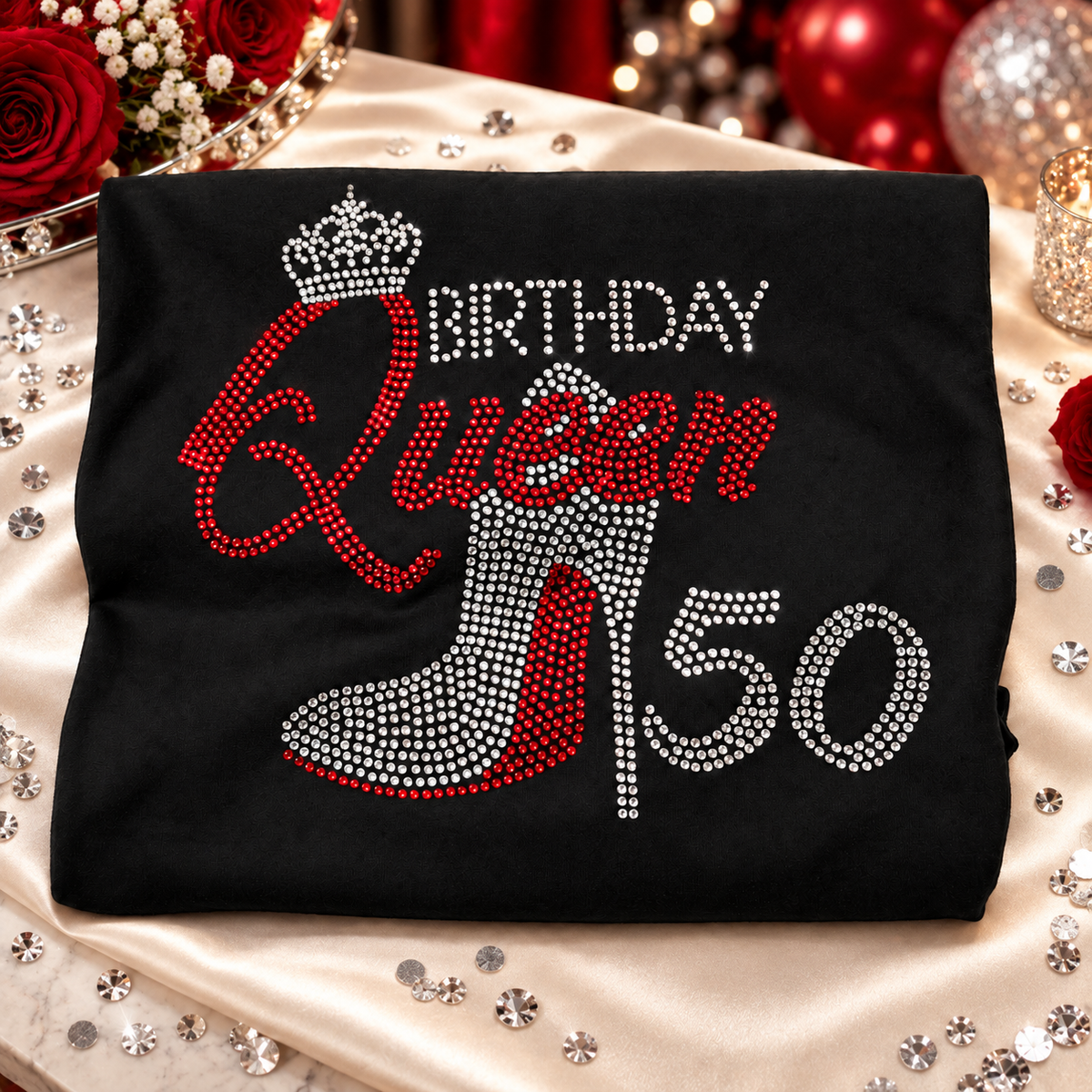 Birthday Queen 50 rhinestone shirt on satin display table with red roses and silver sparkle