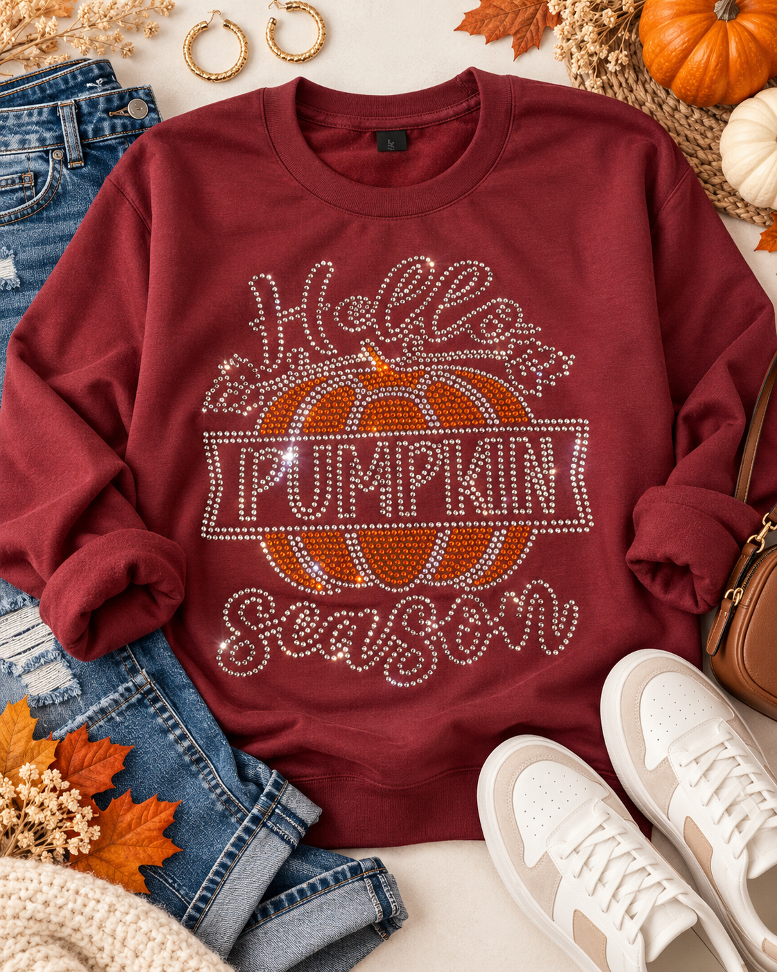 Styled flat-lay of Ready to Ship — Hello Pumpkin Rhinestone Sweatshirt | Burgundy with jeans and sneakers