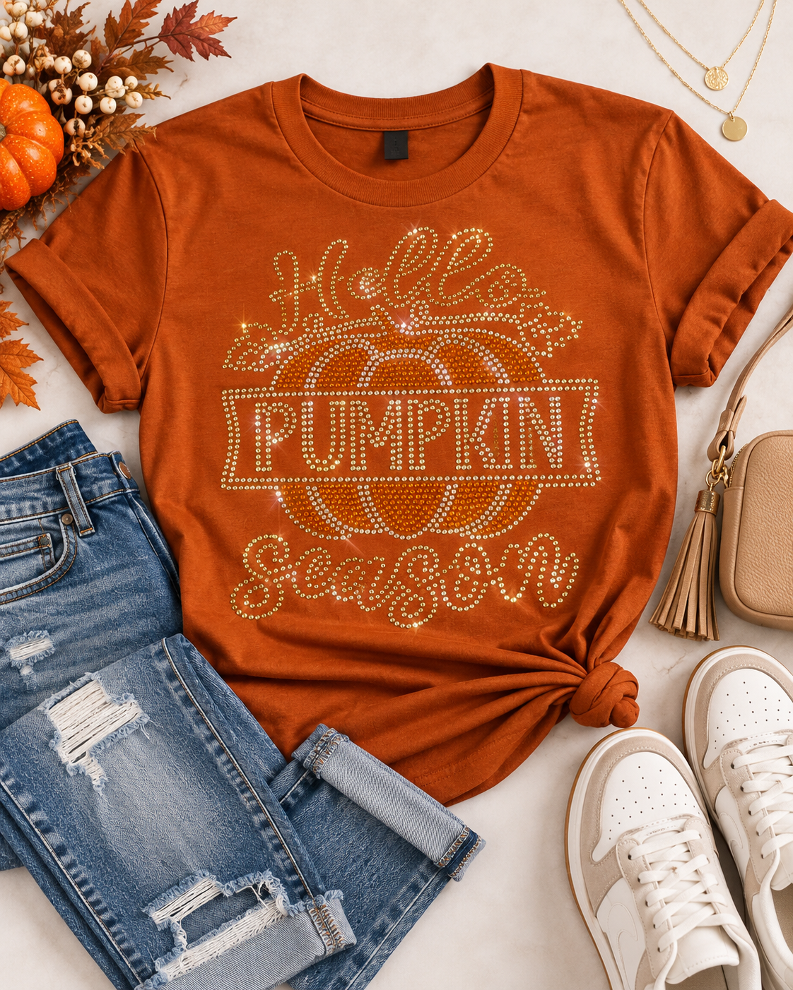 Styled flat-lay of Ready to Ship — Hello Pumpkin Season Rhinestone T-Shirt | Burnt Orange with jeans and sneakers